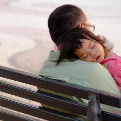 Child asleep in parents arms