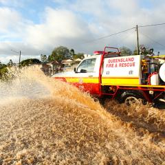 Fire and rescure truck driving through flood waters